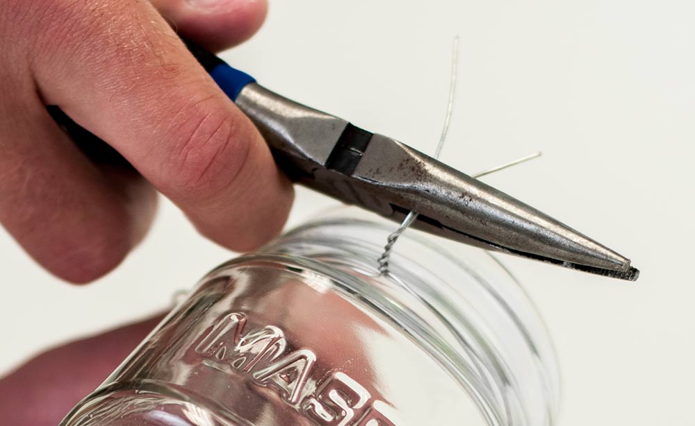 Snipping excess wire from the mason jar