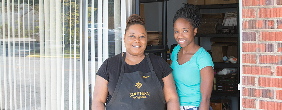 D'Shawn standing at the entrances of her Southern Elegance Candle Studio