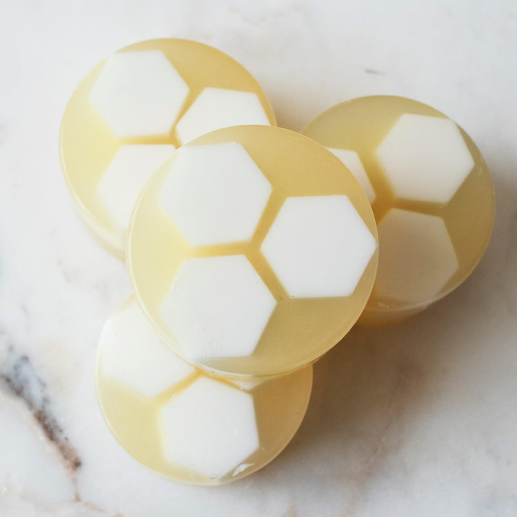 Closeup of honeycomb facial soap stacked on a table.