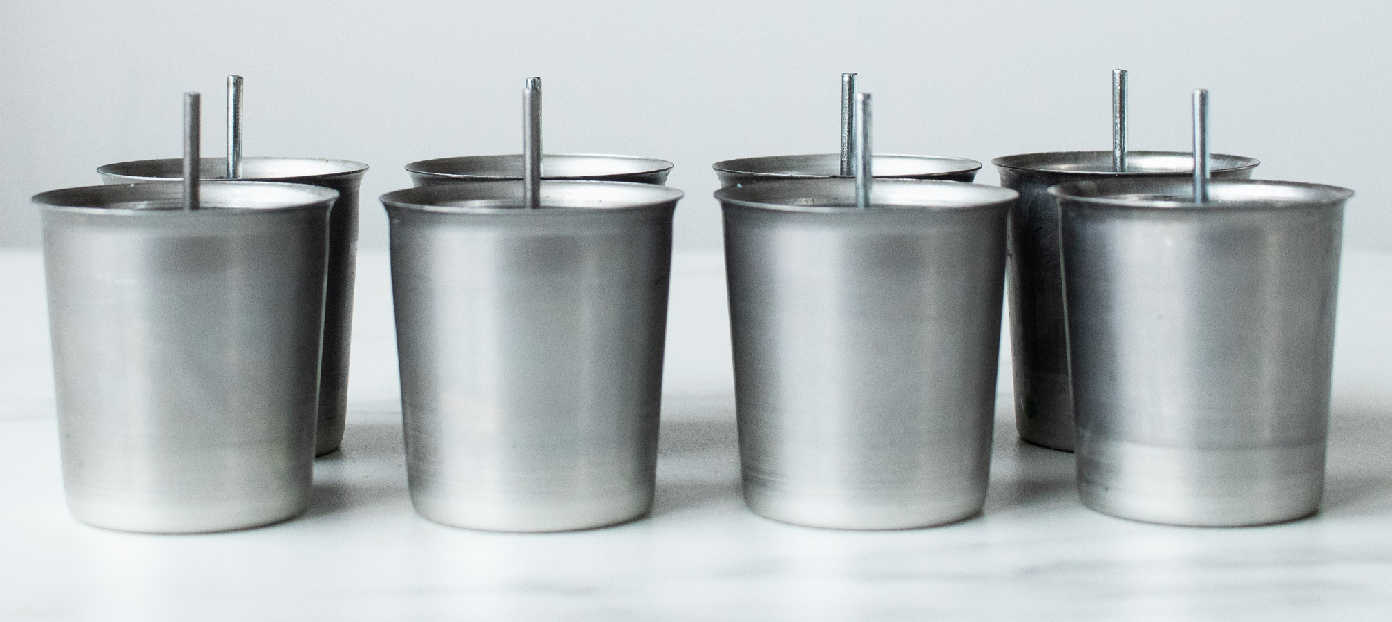 How to make votive candles Wick pins in votive molds.