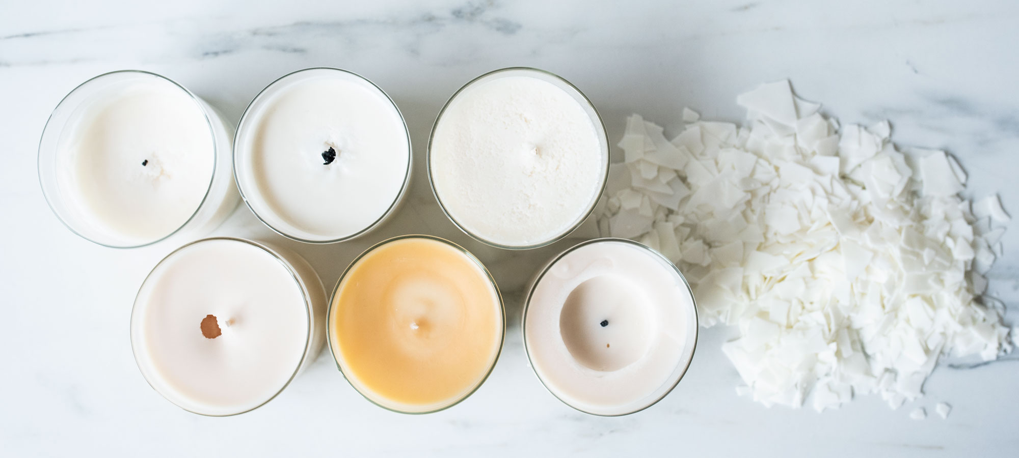 Soy Wax Trouble Shooting - Soy wax candles on table with common issues. 