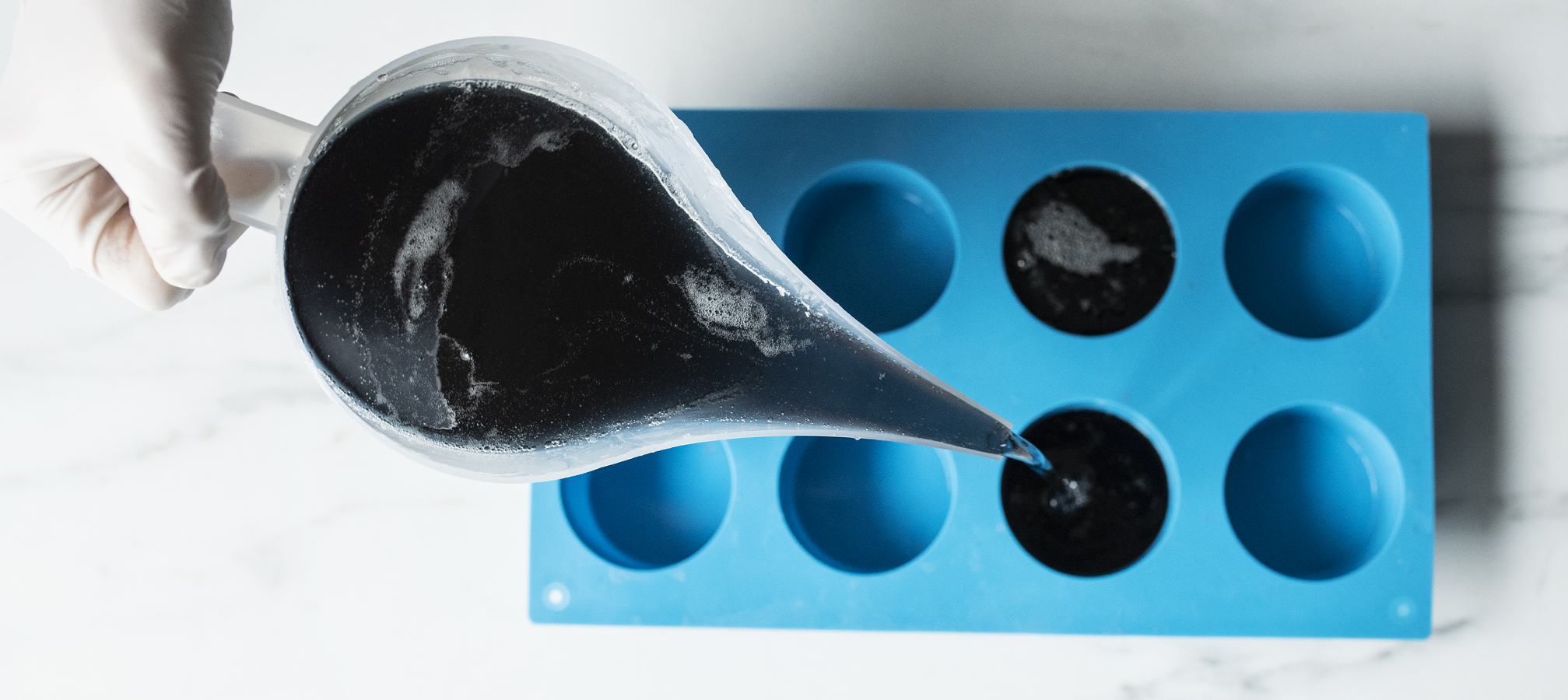 Pouring soap into round silicone mold