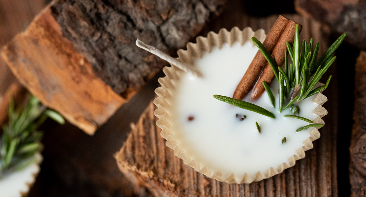 Wax fire starter with rosemary and cinnamon stick on a log