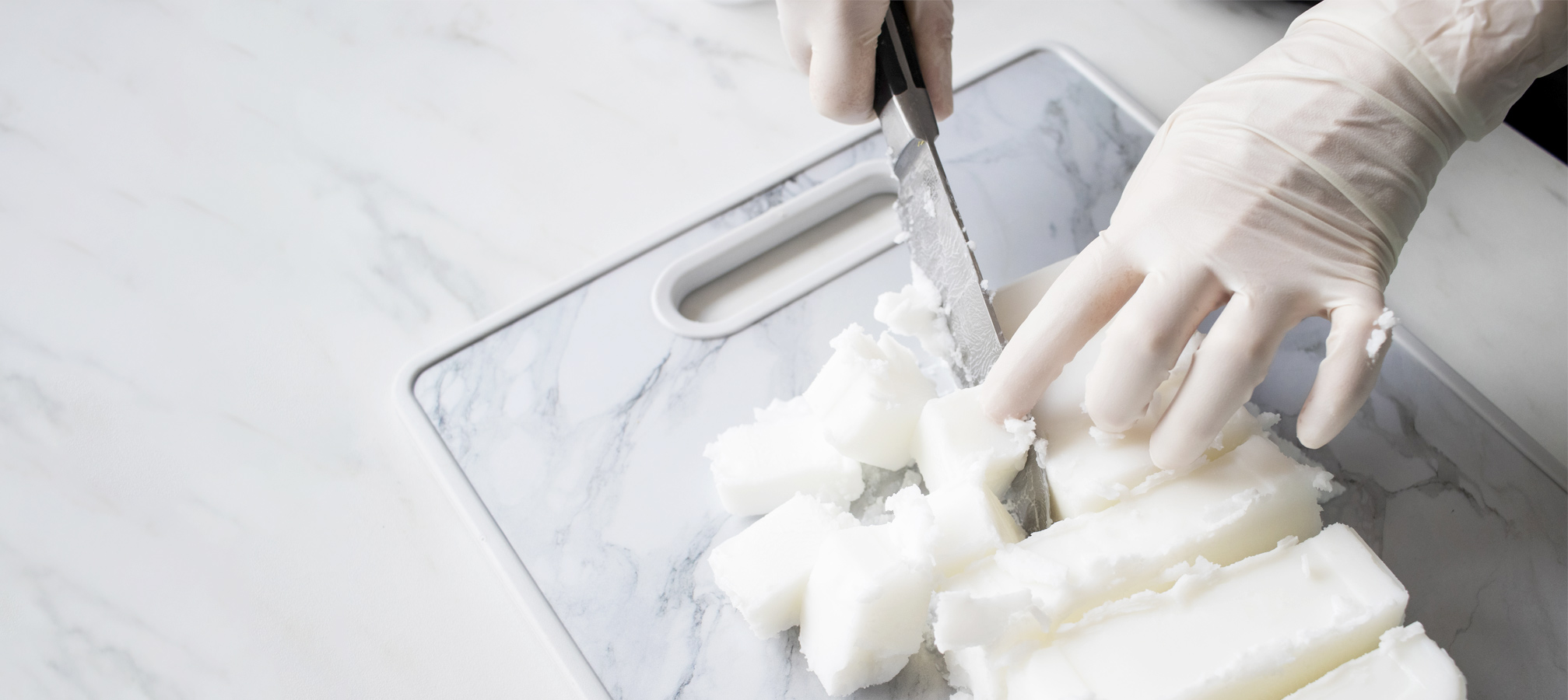 Cutting melt and pour soap base on a cutting board