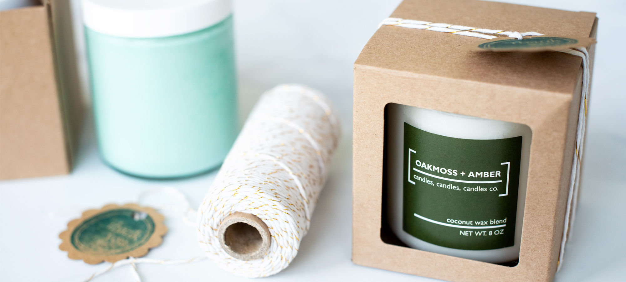 A packaged candle with baker's twine ready to sell on Etsy.