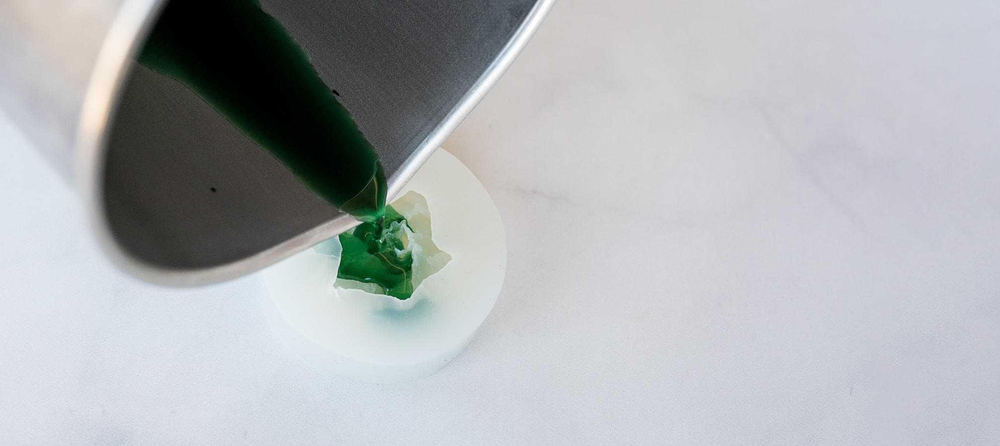 Pouring beeswax into silicone succulent mold.