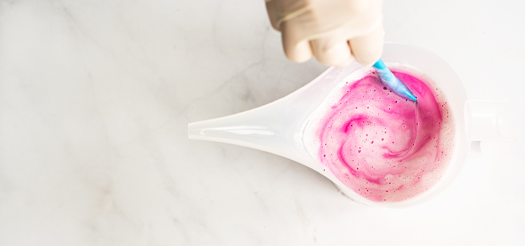 Magenta liquid dye swirled in melt and pour soap.