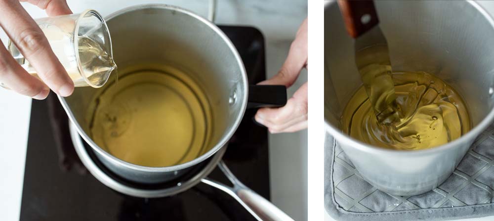 Pouring fragrance oil into melted soy wax flakes.