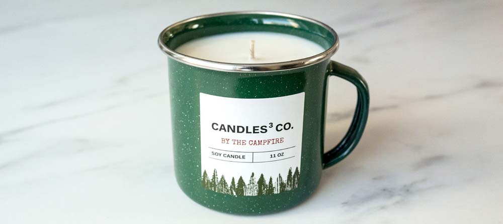 How to Make Enamel Mug Candles Close up of a green enamel mug candle with a label.