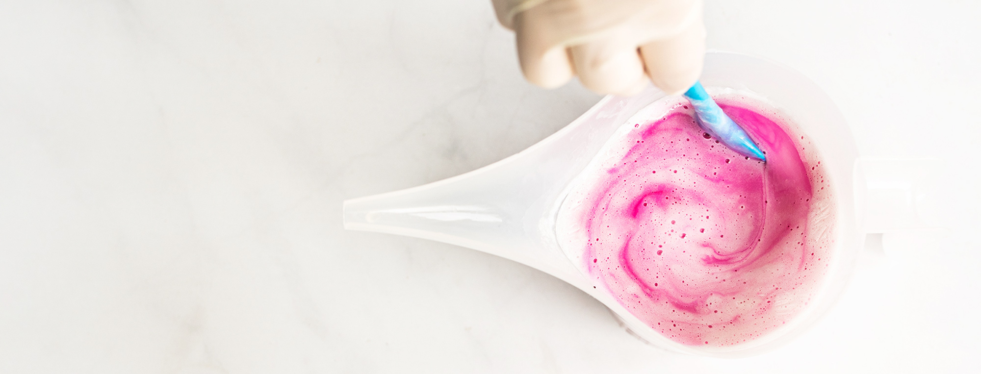 Magenta liquid soap dye swirled in melt and pour soap.