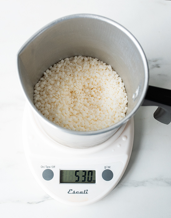 Weighing wax on a digital scale.