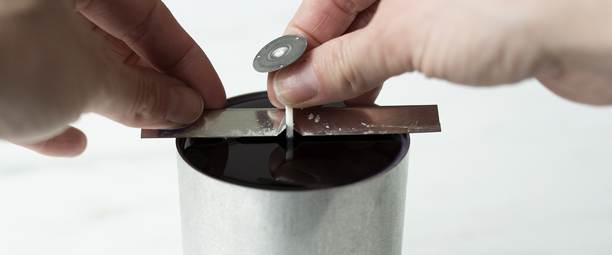 Setting a wick bar on a pillar mold.