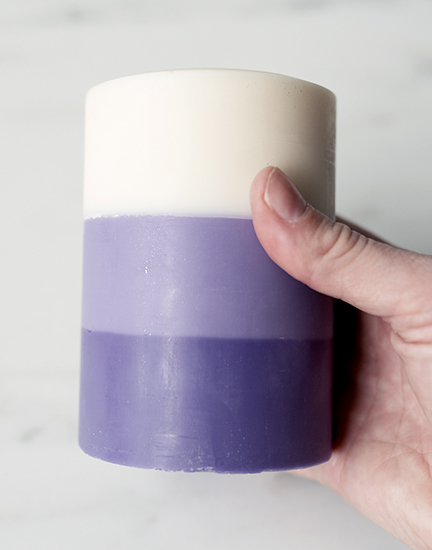 Holding a finished layered pillar candle.