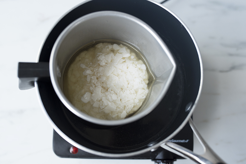 Melting soy wax flakes in a double boiler.