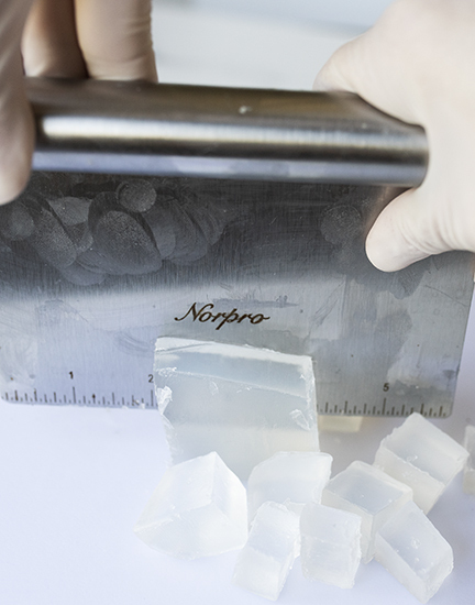 Cutting melt and pour soap base into cubes.