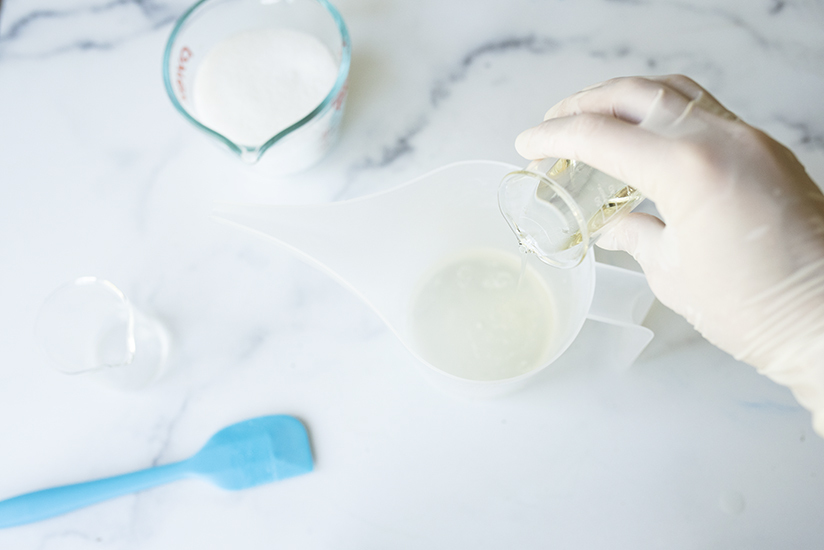 Pouring oil into melted soap base.