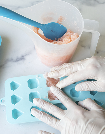 Pressing sugar scrub into silicone mold