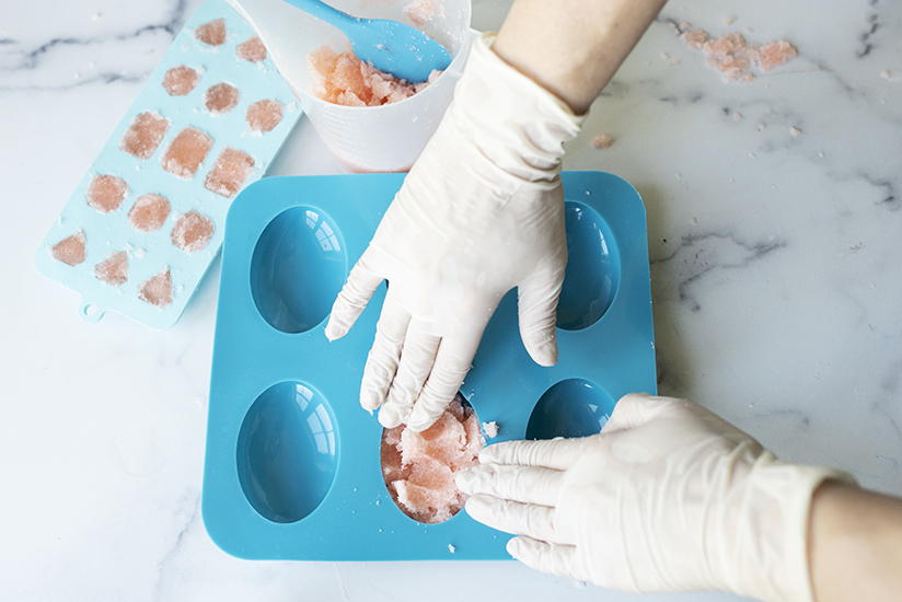 Pressing sugar scrub into silicone mold