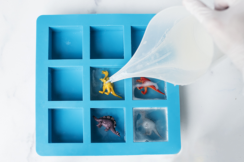 Pouring soap into a soap mold.