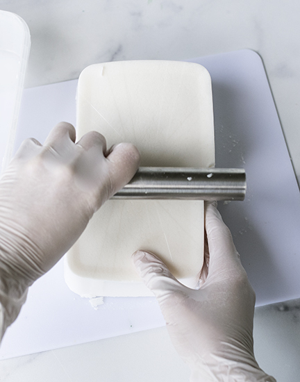 Cutting cosmetic soap base in half.