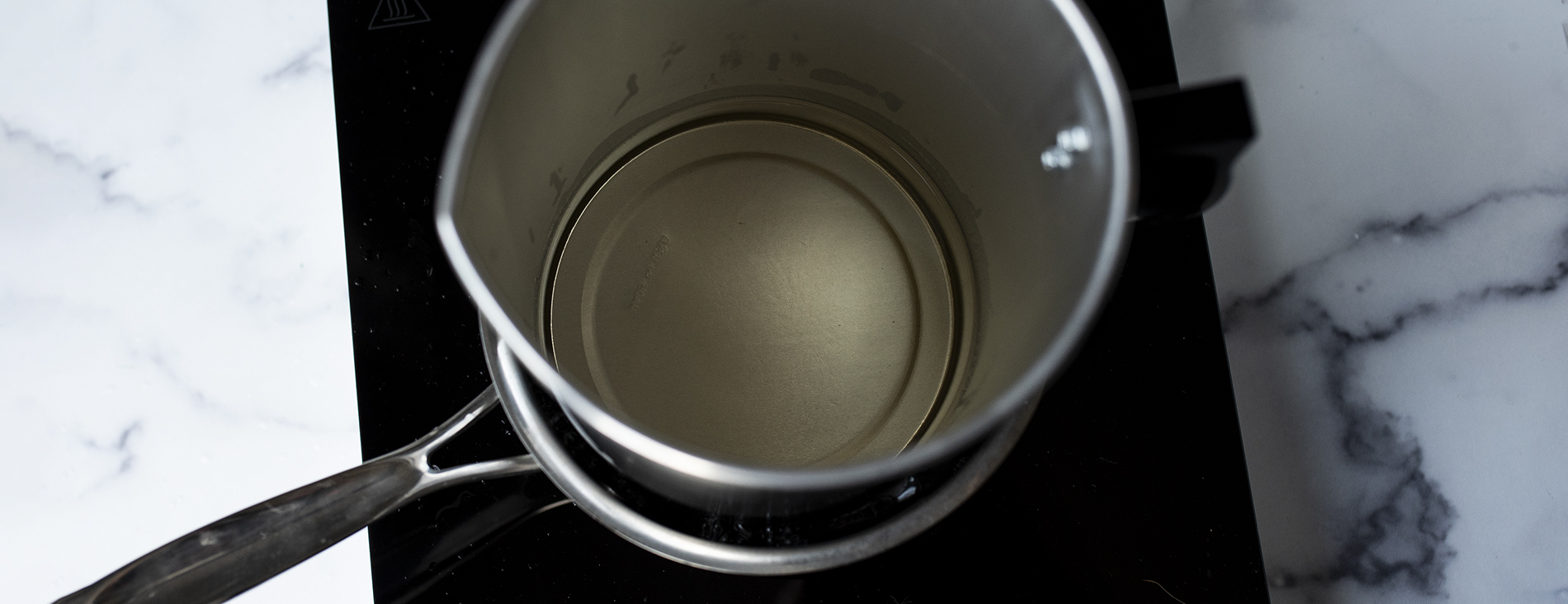 Melted cosmetic base in a double boiler.