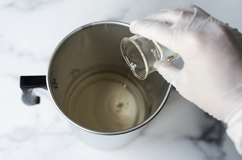 Pouring fragrance oil into melted base.