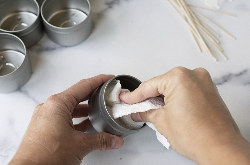 Cleaning out tin with paper towel and rubbing alcohol.