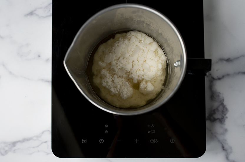 Weighing soy wax flakes on a digital scale.