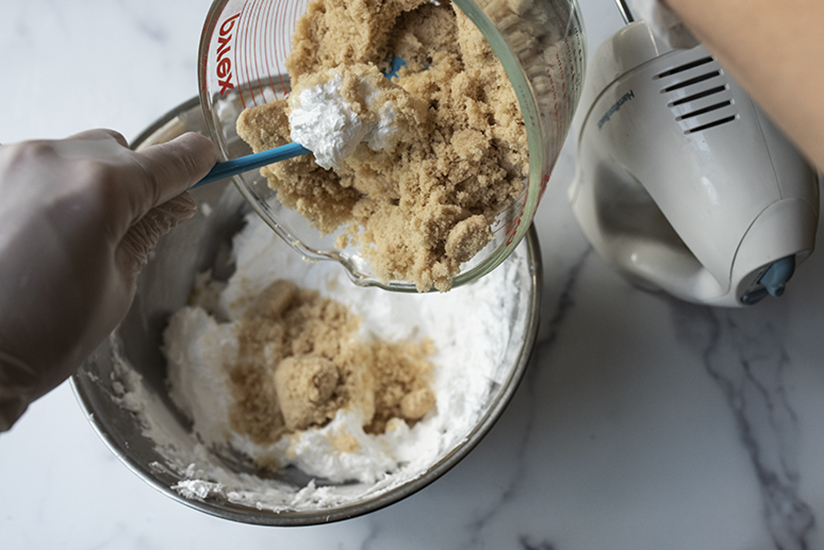 Adding brown sugar to whipped foaming bath butter base.