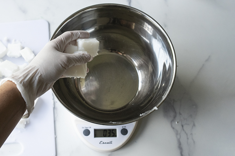 Adding cubed base to bowl for weighing.