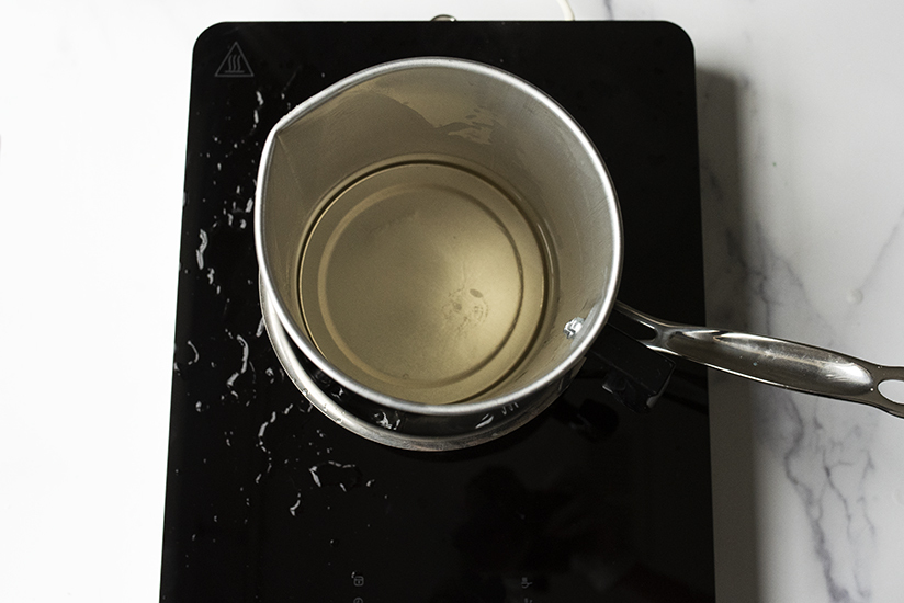 Melted cosmetic base in a double boiler.