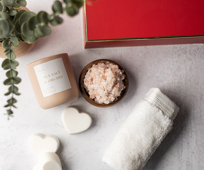 Self love spa gift box with salt scrub, candle, and shampoo bars.