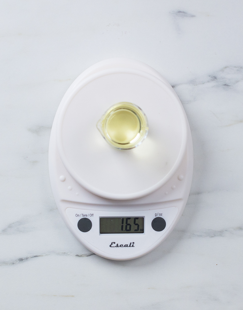 Weighing fragrance oil on a digital scale.