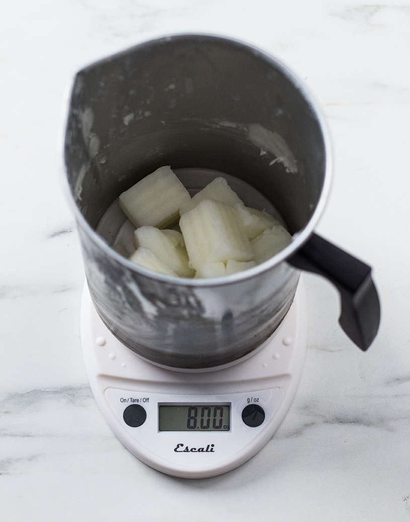 Weighing wax on a digital scale.