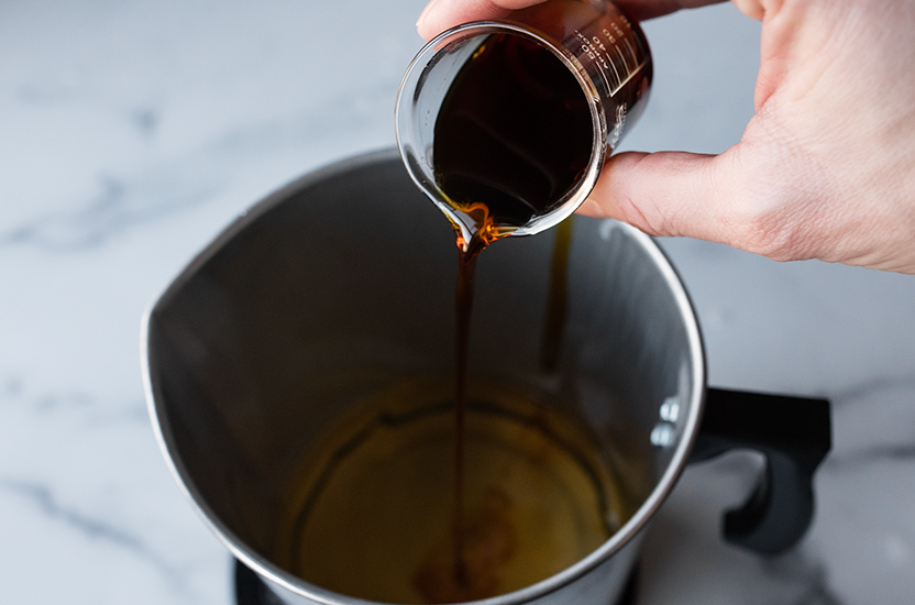 Pouring oil into melted wax.