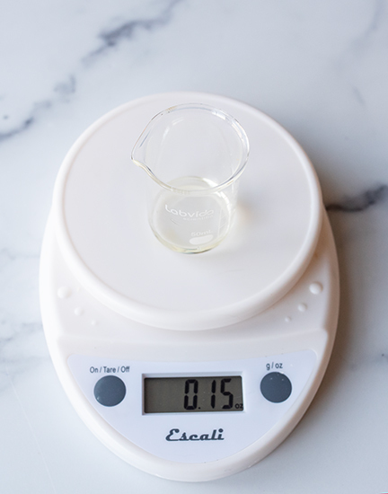 Weighing essential oil on a digital scale.