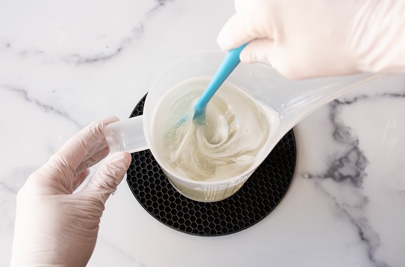 Stirring essential oil into melt and pour soap.