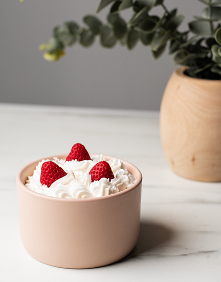 Candle with whipped wax and strawberry wax embeds.