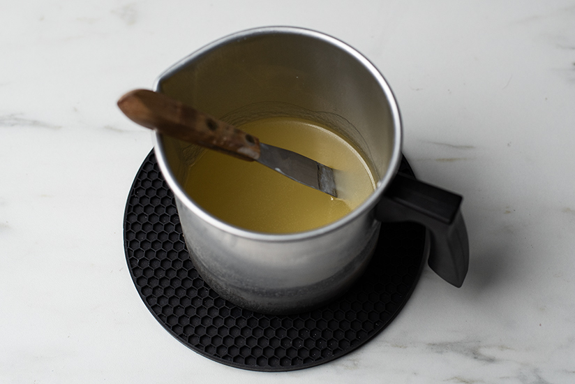 Soy wax cooling in a pouring pitcher.