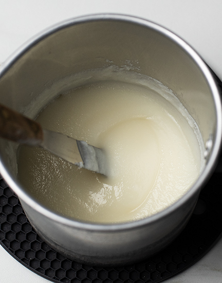 Soy wax cooling in a pouring pitcher.