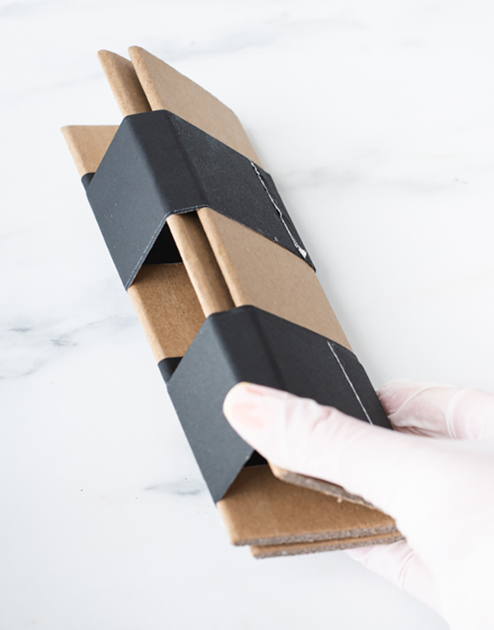 Cardboard folded into a triangle held together by tape.
