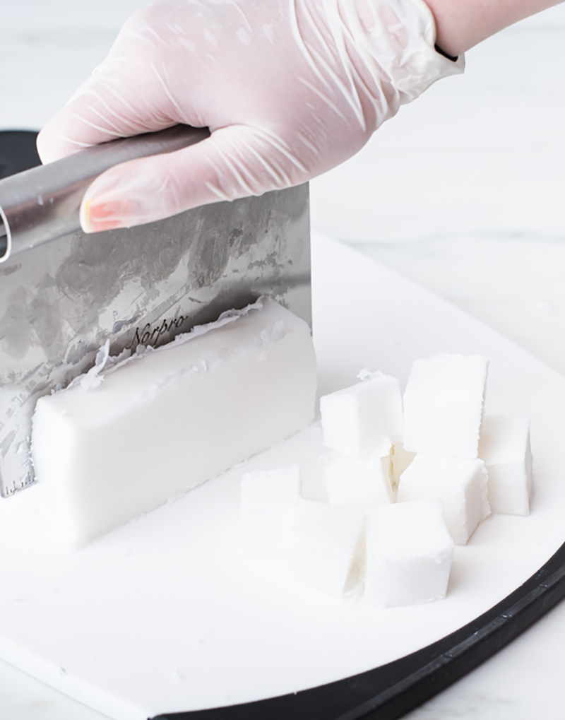 Cutting soap base into cubes.