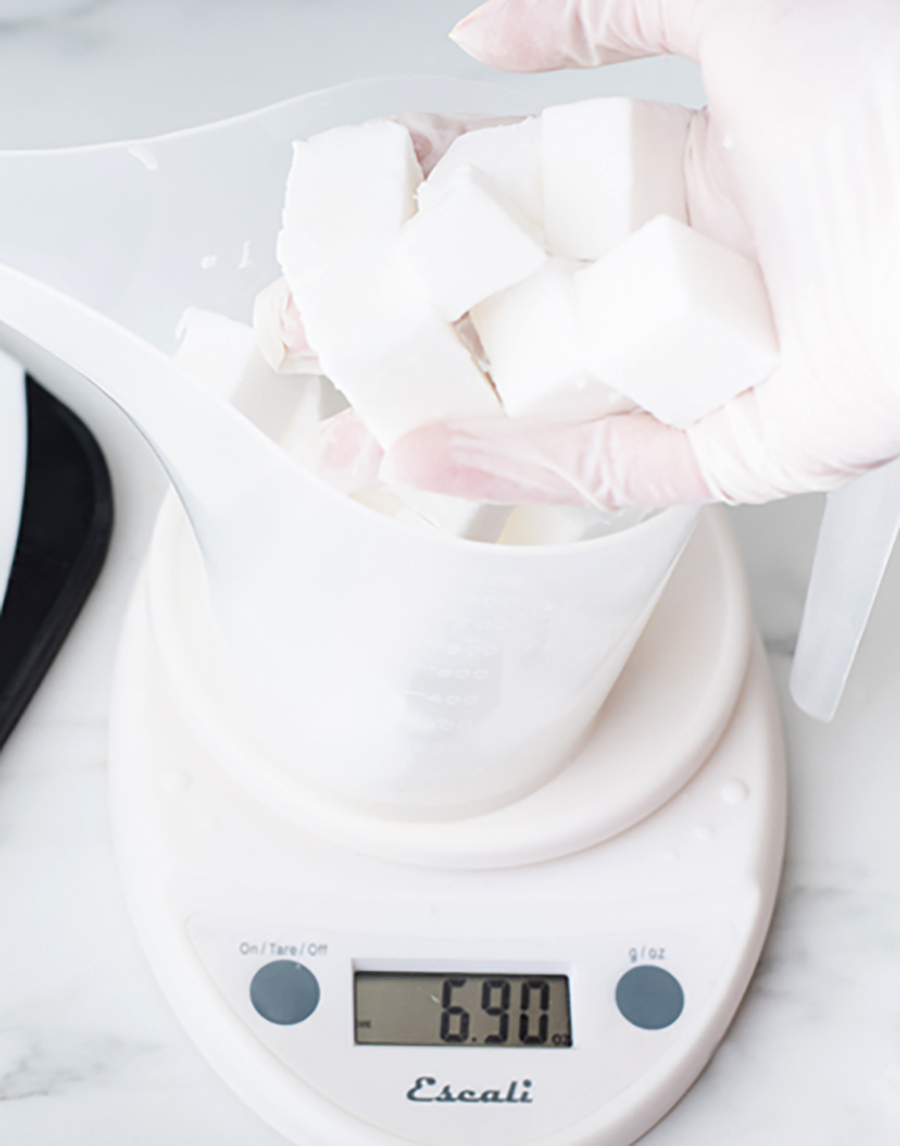 Adding soap cubes to a funnel pouring pitcher.