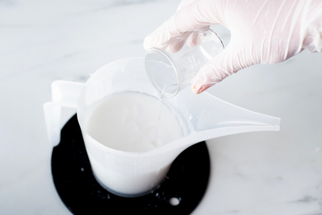 Pouring fragrance oil in melted soap.