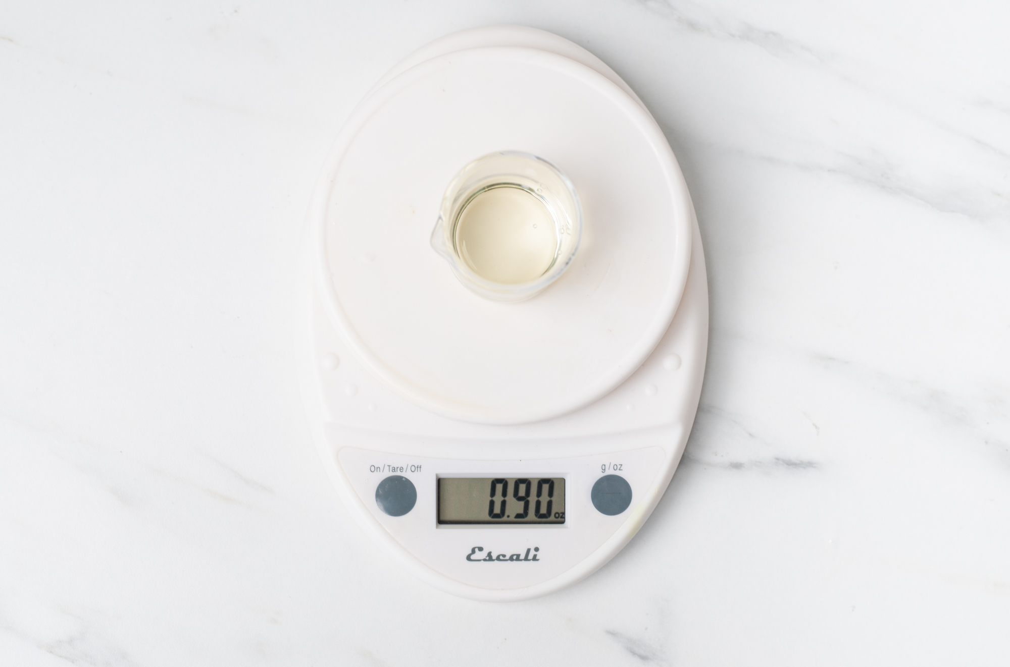 Weighing fragrance oil on a digital scale.