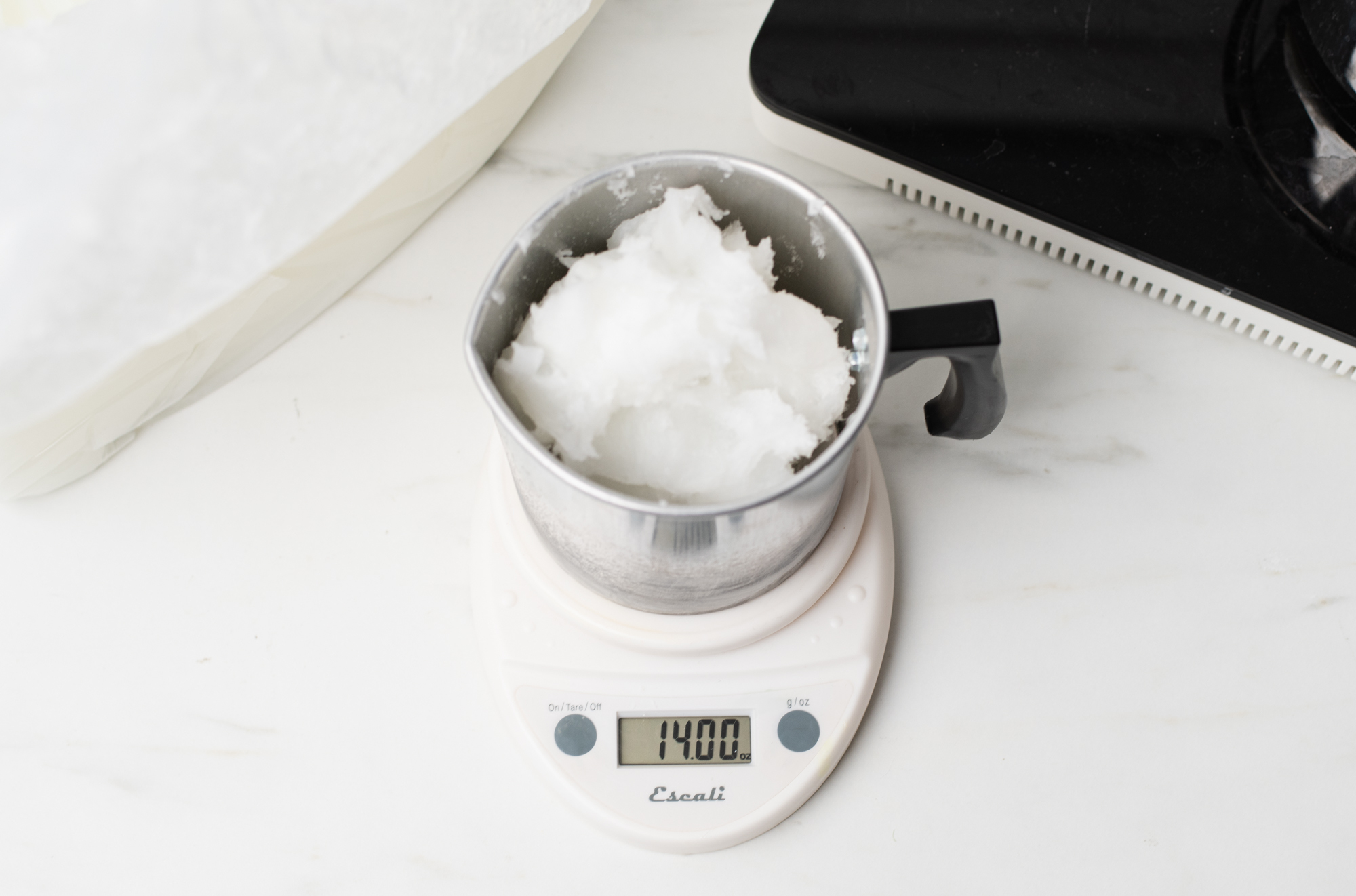 Weighing wax on a digital scale.