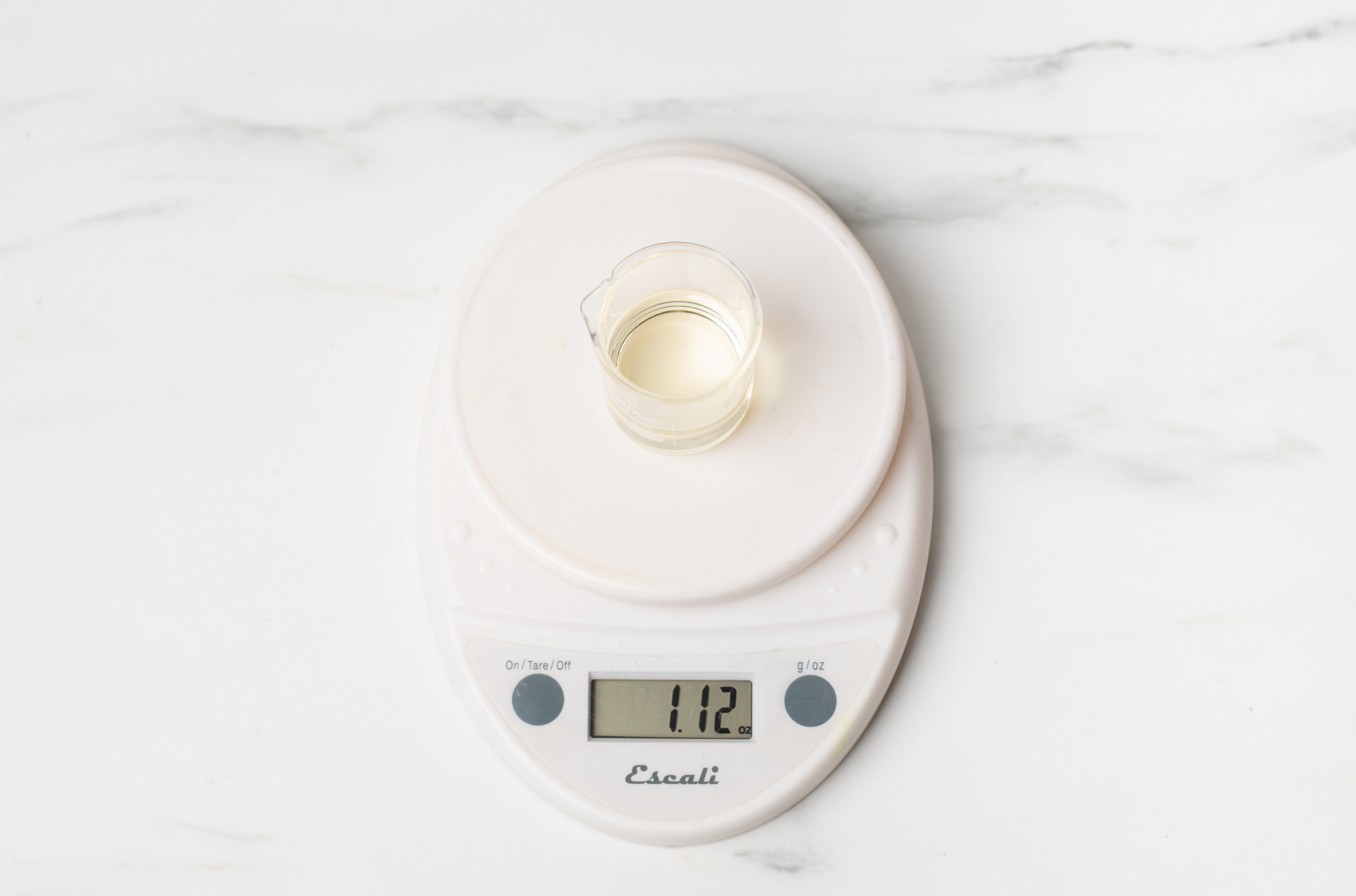 Weighing fragrance oil on a digital scale.