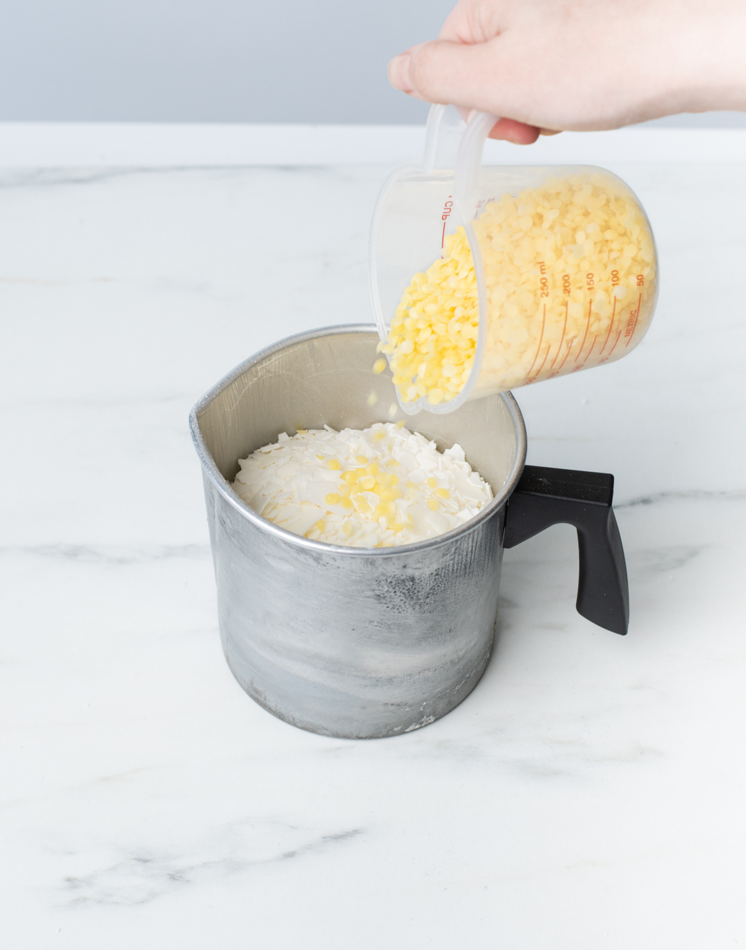 Combing waxes into one pouring pitcher.