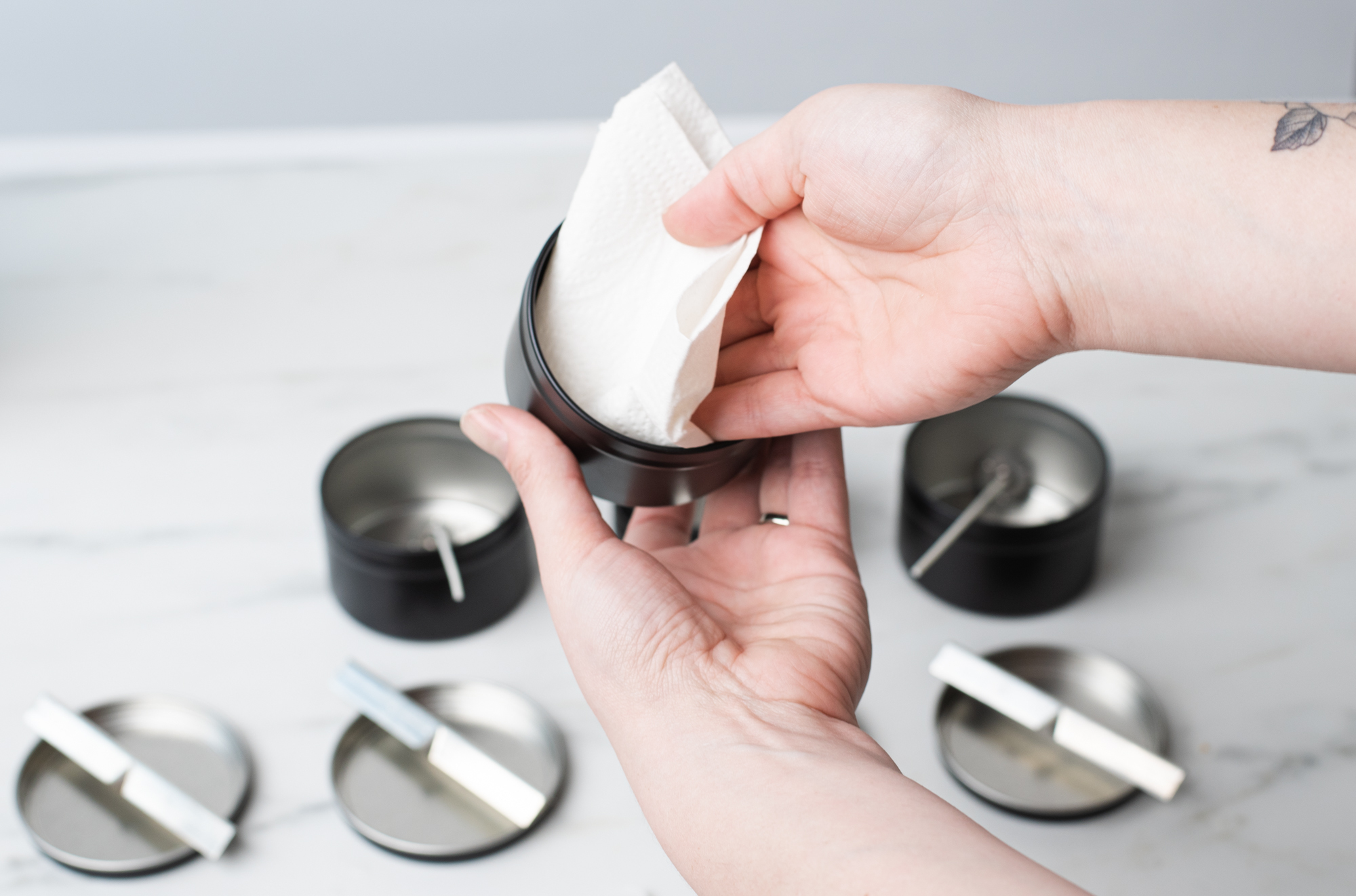 Cleaning out candle tins for candle making.