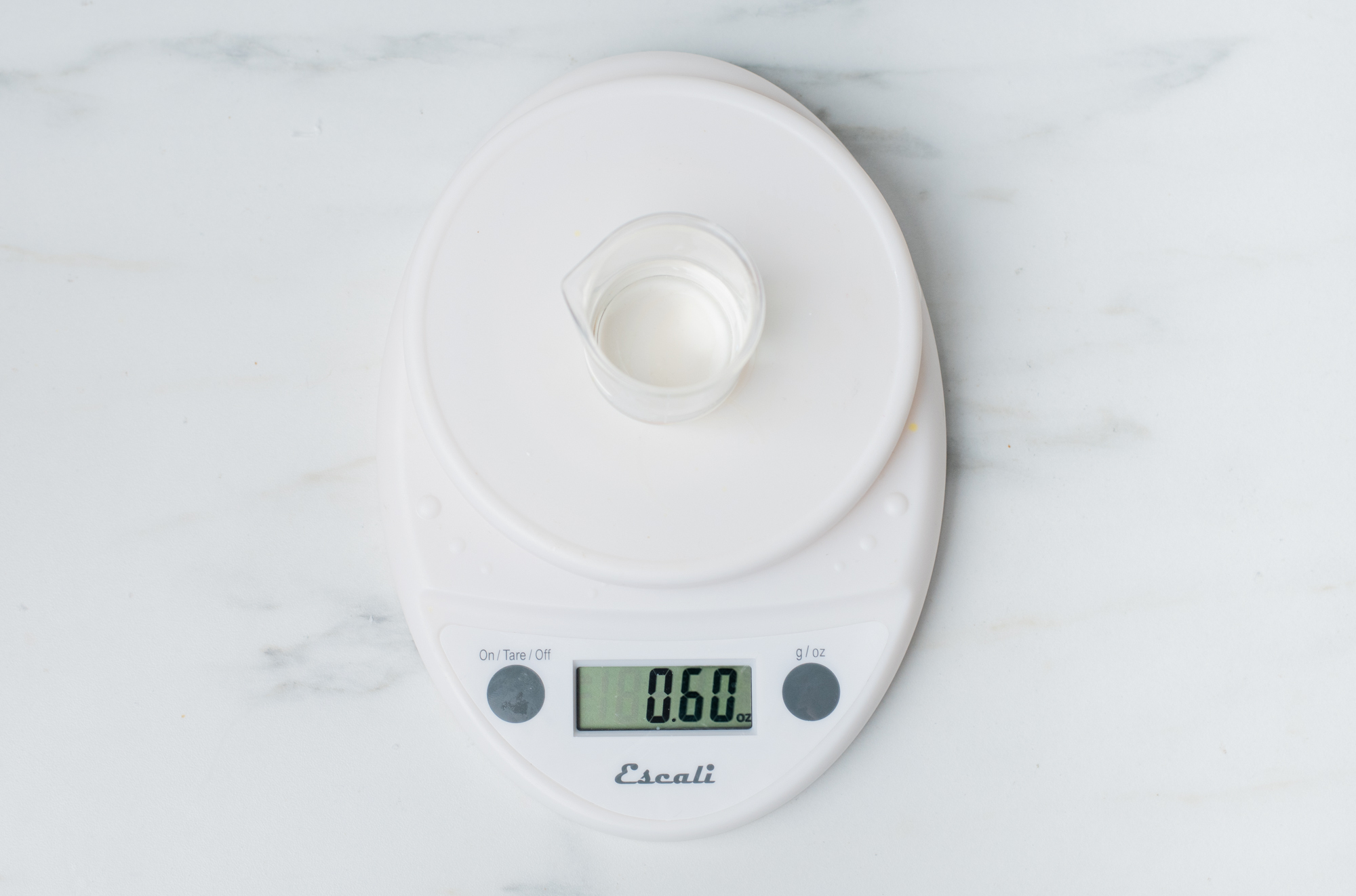 Weighing fragrance oil on a digital scale.